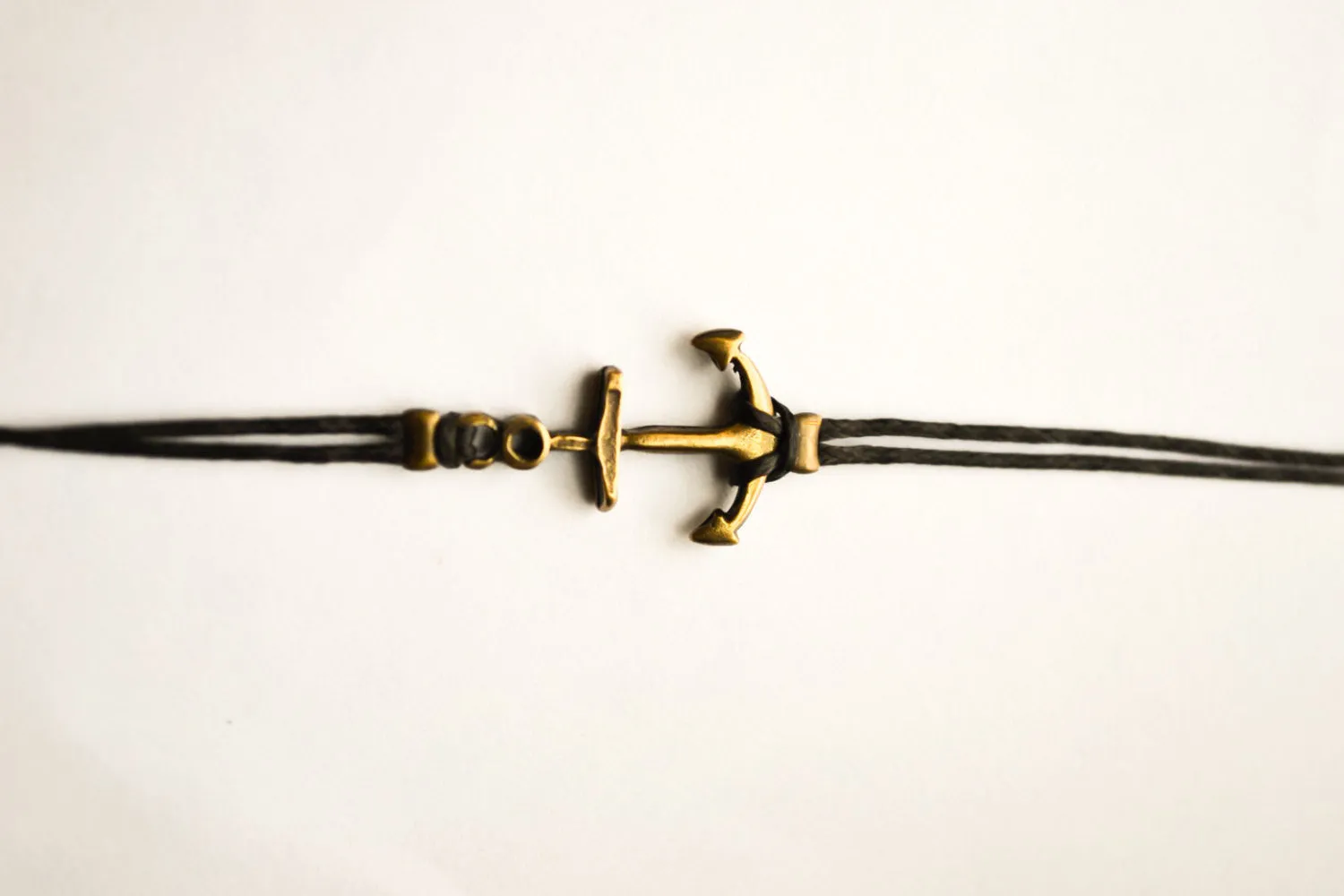 Bronze anchor bracelet for men with black cord, nautical surfer jewelry